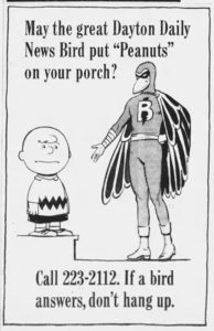 Charlie Brown posing with a bird superhero character