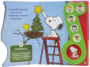 Page spread showing Snoopy on a ladder putting a star on a tree while Woodstock watches