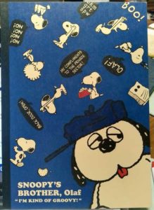 A picture of a notebook with a large image of Olaf and nine small images of Snoopy. Text: Snoopy's brother Olaf "I'm kind of groovy!"
