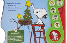 Page spread showing Snoopy on a ladder putting a star on a tree while Woodstock watches